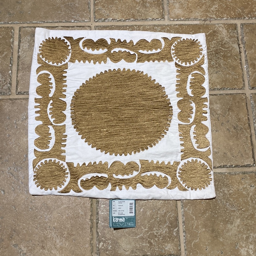 Karma Living beige pillow cover with gold embroidery.
